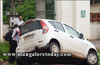 With driver talking over cell phone, car almost lands in drain